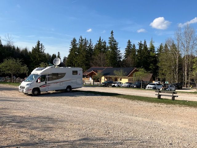 Motorhome in a parking lot in front of a building in the Hohe Wand Nature Park.
